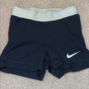 Black Nike pros with green band
